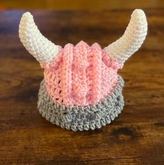 a crocheted hat with horns is sitting on a table