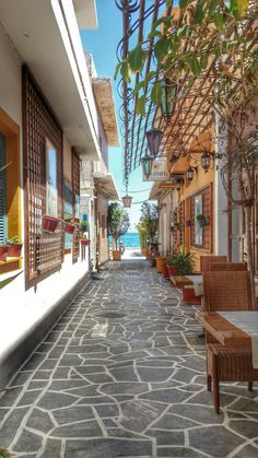 an empty street with chairs and tables on it