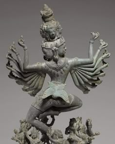 a statue with many arms and legs in the shape of a woman holding two hands