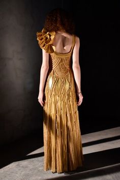 Golden yellow padded gown featuring hand sewn braids all over with a structured flower on the shoulder. - Aza Fashions Couture Sleeveless Gala Gown, Yellow Sleeveless Dresses For Reception, Yellow Sleeveless Gown For Gala, Gold Sleeveless Reception Dress, Yellow Sleeveless Evening Gown, Sleeveless Yellow Evening Gown, Luxury Yellow Gala Dress, Gowns Gold, Gown Gold