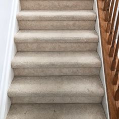 a carpeted staircase leading up to the second floor