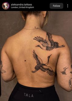 the back of a woman's body with tattoos on her upper and lower back