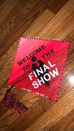 the final show poster is laying on the floor next to a pair of scissors and yarn