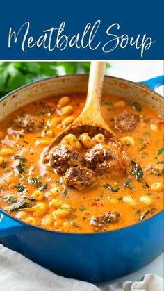 meatball soup in a blue pot with a wooden spoon and parsley on the side