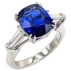 Platinum hand made ring with two tapered baguette diamonds totaling 0.56 carats (G color / VS clarity) and one center cushion cut Ceylon sapphire 5.14 carats. * Includes certificate for center stone * Finger size 7. Can be resized. Ring With Baguettes, Ceylon Sapphire, Baguette Diamonds, Three Stone Rings, Baguette Diamond, Three Stone, Cushion Cut, Estate Jewelry, Fashion Rings