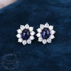 "❤Jewelry Details -Gold Type: Solid 14K Gold / Solid 18K Gold (Choose One in Material Option) Center Stone: Lab Created Blue Sapphire 7*9mm, Approximately 2.65ct*2pcs Color: 5A Clarity: VVS Cut: Oval Cabochon Cut / 3EX Side Stone: Moissanite, 3.5mm*20pcs Side Stones Total Carat Weight: 3.0ctw Color: EF Clarity: VVS1 Cut: Round Cut / 3EX SKU: YE0052 ~*-*~Purchase Guarantee: - All our jewelry is handmade, and each process is refined. - 14 Day Refund Guarantee. - All our products are Free Shipping. Elegant Blue Oval Cabochon Earrings, Oval Cabochon Earrings For Anniversary, Blue Oval Hallmarked Earrings, Oval Sapphire Earrings Fine Jewelry, Fine Jewelry Sapphire Oval Earrings, Oval Sapphire Earrings Hallmarked, Oval Sapphire Earrings With Halo Setting, Fine Jewelry Oval Cabochon Earrings For Anniversary, Oval Cabochon Gemstone Earrings For Anniversary