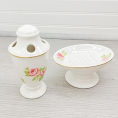 two white dishes with pink flowers on them