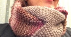 a close up of a person wearing a knitted cowl neckwarmerf