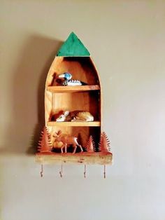 there is a wooden shelf that has some items on it and an animal figurine next to it