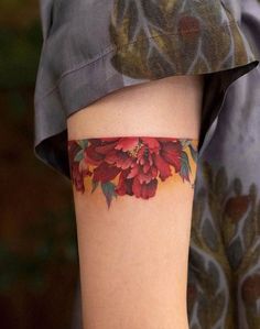 a woman with a flower tattoo on her arm