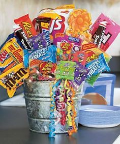 a bucket full of candy sitting on top of a table