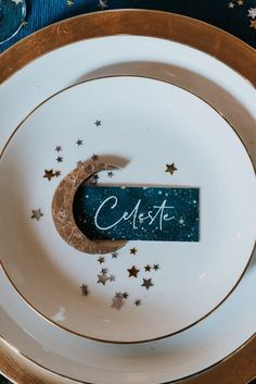 a white plate topped with a crescent and stars next to a sign that reads celese