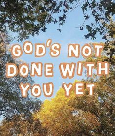 the words god's not done with you yet are written in front of trees