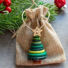 a small wooden christmas tree ornament in a burlap bag on a table