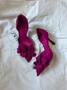 two pairs of purple high heels with flowers on them