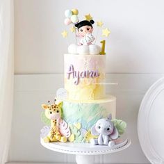 a multi layer cake decorated with animals and stars