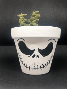 a potted plant with a skeleton face painted on it