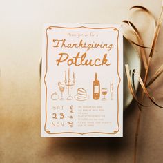 there is a thanksgiving potluck card on the table next to some wine glasses