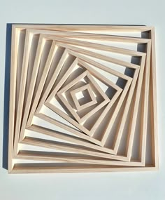 an abstract wooden artwork piece on a white wall