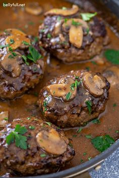 some meatballs with mushrooms and sauce in a pan