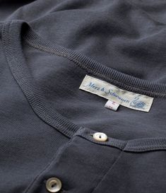 The 206 from Merz B. Schwanen is a timeless classic. This three button Henley is brilliantly cut in a standard fit tee, a little slimmer than the 204, and is made from beautiful materials. The 100% organic cotton has been expertly woven using vintage loop wheel looms to produce a fabric which is not only luxuriously comfortable, but incredibly durable. Three ivory coloured buttons help to secure the breast plate, adding a convenient opening for when the weather gets warmer. Ribbed cuffs have bee Breast Plate, Ink Blue, Mother Of Pearl Buttons, Blue Ink, Clothing Co, Ivory Color, Layering Pieces, Timeless Classic, Workout Tee