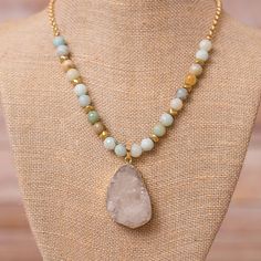 Short Beaded Necklace with Druzy Pendant - This 18" Necklace is beautifully detailed with amazonite beads and a teardrop shaped white druzy pendant. Matte Gold Plated for a warm golden finish that has a subtle glow. Resists Tarnishing Handmade in Florida Due to the handcrafted nature of our product, all items will vary slightly. Each pendant will vary slightly in color and size. Bead Necklace With Pendant, Gold Single Strand Amazonite Beaded Necklace, Gold Single Strand Beaded Necklace With Amazonite, Beaded Necklace With Pendant, Short Beaded Necklace, Multi Layer Necklace Beads, Short Necklaces, Jade Bead Necklace, Necklace With Pendant