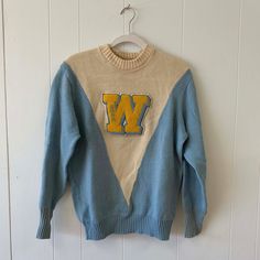 "Vintage Authentic Pieced Knit Cheerleading Sweater Incredible color-blocked and pieced V- shape Ribbed turnback cuffs Custom \"W\" Boucle stitched on patch that reads \"Shar\"  Faded name on tag says \" Sharon Wiig\"  Slight wear and pilling but overall great vintage condition   100% Wool Albion Knit : Made in Los Angeles No size label but fits like a Medium  Length from shoulder to hem (flat) - 20 in  Width from armhole to armhole (flat) - 16.5 in" Retro Color Block Sweater For Winter, Retro Color Block Winter Sweater, Retro Winter Color Block Sweater, Varsity Sweater For Game Day In Winter, Game Day Crew Sweater For Winter, Collegiate Sweater For Game Day In Winter, Game Day Winter Crew Sweater, Collegiate Game Day Winter Sweater, Sporty Patchwork Sweater For Winter