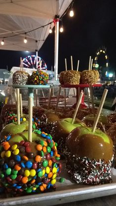 there are many candy apples on the tray