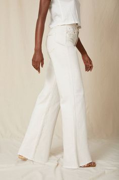 Make a statement in our best-selling high-rise, wide leg silhouette. With an easy fit though the hip and thigh, full inseam, slight distressing at the pockets and a raw frayed hem, they're your new everyday denim. Zip fly. WASH: WHITE OAK FIT & MEASUREMENTS: Inseam = 33" Front Rise = 13" Back Rise = 16" Leg Opening = 23" Measurements taken from size 27 Taliha is wearing a size 24 and is 5'10" Take your normal size for a full easy fit, or size down to be more fitted around the waist Fabric & Care Mid-rise Flare Jeans With Frayed Hem, Spring Straight-cut Rigid Denim Flare Jeans, High Rise Flare Jeans With Relaxed Fit, Chic Flare Jeans With Frayed Hem For Work, Spring Rigid Denim Flare Jeans With Straight Hem, High Waist Flare Jeans With Frayed Hem For Work, Straight Leg Bottoms With Frayed Hem For Work, Fitted Wide Leg Cropped Jeans With Frayed Hem, Spring Flare Jeans In Rigid Denim With Standard Cut