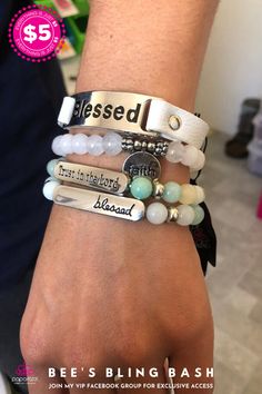 a person wearing bracelets with words and charms on their wrist, both saying blessing