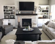 a living room filled with furniture and a flat screen tv mounted above a fire place