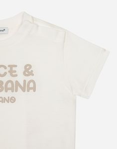 Cotton jersey T-shirt with rubberized Dolce & Gabbana logo print: Beige Regular fit Stretch knit round neck Short sleeves Concealed press-stud fastenings on the shoulder The item in the size 6/9 months measures 31 cm from the shoulder seam Made in Italy Press Studs, Dolce And Gabbana, Short Sleeves, T-shirt, ? Logo, T Shirt