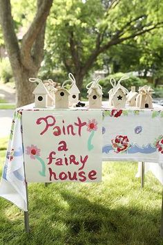 an image of a party table with decorations on it and a sign that says paint a fairy house