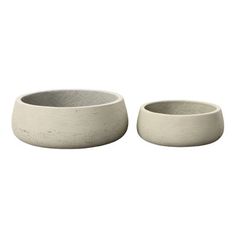 two white bowls sitting next to each other