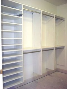 an empty walk in closet with white shelving and no one standing on the floor