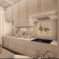 an image of a kitchen setting with white cabinets and flowers in vases on the counter