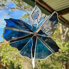 a stained glass flower hanging from a chain