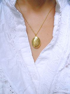 "A golden oval locket hangs from a gold chain. Please select a length from the drop-down box. The locket measures 1\" x 3/4\". *We do not personalize nor insert pictures. The locket and chain are gold plated over brass, so it's recommended removing before showering, swimming, etc. to keep jewelry looking like new." Gold Oval Locket Necklace For Keepsake, Gold Oval Pendant Locket Necklace For Keepsake, Personalized Gold Locket Necklace With Oval Pendant, Oval Locket Necklace, Gold Heart Locket, Oval Locket, Heart Locket Necklace, Jan 1, Two Hearts