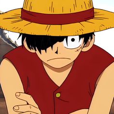 a man wearing a straw hat with his hands on his chest and looking at the camera