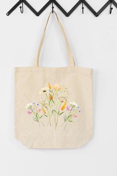 Check out our Watercolor Flower Bouquet Canvas Tote Bag! This stylish and practical tote bag features a beautiful watercolor flower design tis perfect for spring. Ideal for carrying your essentials, this bag is made from high-quality canvas material that is both durable and easy to clean. It's great for everyday use or as a gift for a friend or loved one. Get yours today and add a touch of beauty to your everyday style! Eco-friendly Floral Canvas Bag For Everyday Use, Eco-friendly Everyday Bags With Floral Print, Botanical Flower-shaped Bag For Daily Use, Everyday Botanical Style Bag With Plant Print, Botanical Flower-shaped Bags For Daily Use, Everyday Botanical Bags With Plant Print, Botanical Flower Shaped Bags For Daily Use, Eco-friendly Flower-shaped Bags For Spring, Botanical Bags With Plant Print For Everyday Use