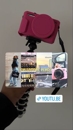 a person holding up a pink camera to take a picture with it's phone