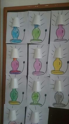 a bunch of different colored lamps sitting on top of a white wall next to each other