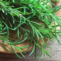 fresh rosemary leaves in a wooden bowl