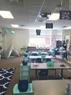 an empty classroom with tables and chairs in it