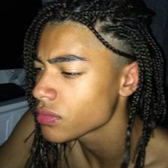 a young man with dreadlocks on his head