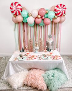 a table topped with candy canes and balloons