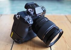 a black camera sitting on top of a wooden table