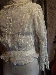 Delicate original condition Edwardian cream/white lace blouse personally sourced directly from the brocante markets of France. Almost perfect condition, just a small tear in the undernet layer under the right armhole, all back hooks in tact. Beautiful lace collar and cuff details. Quite wearable, small size with hook and eye back undernet layer. 32 inch bust, 24 inch waist, 14 inch armscye, 17 inches in length from the shoulder to the hem. Fitted White Victorian Blouse, White Fitted Victorian Blouse, Elegant Fitted Lace Top With Broderie Anglaise, Victorian Lace Blouse For Daywear, Classic Lace Tops For Daywear, Long Sleeve Lace Top With Ruffles For Wedding, Wedding Long Sleeve Lace Top With Ruffles, Fitted Lace Top With Lace Sleeves For Daywear, Elegant Broderie Anglaise Lace Top For Daywear