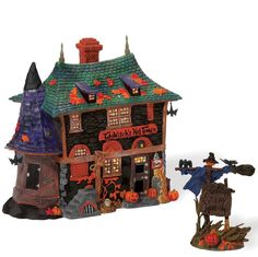 a figurine of a halloween house with a scarecrow on it