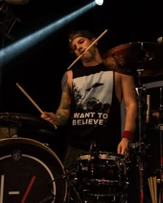 a man is playing drums on stage